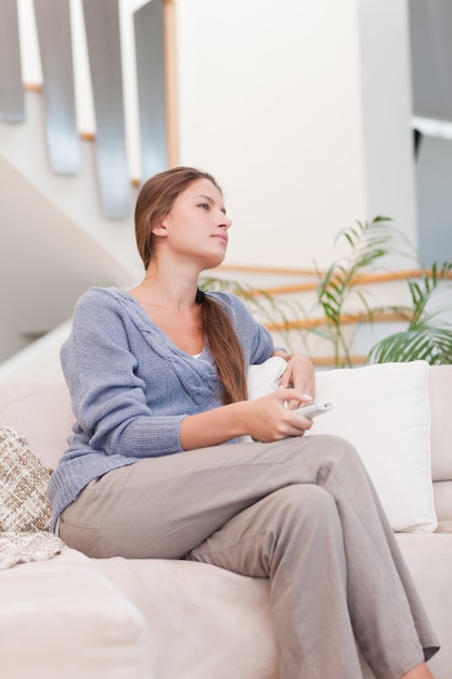 Portrait of a woman watching TV