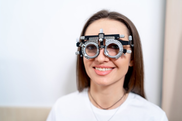 Portrait of woman wearing corrective glasses with replaceable lenses. Ophthalmology clinic.