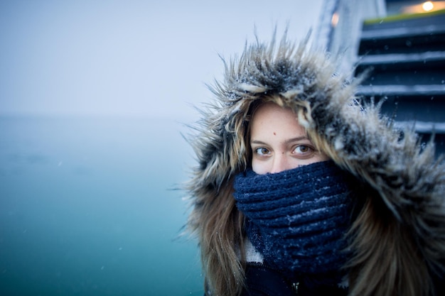 Photo portrait of woman wearing fur coat in boat on sea during winter