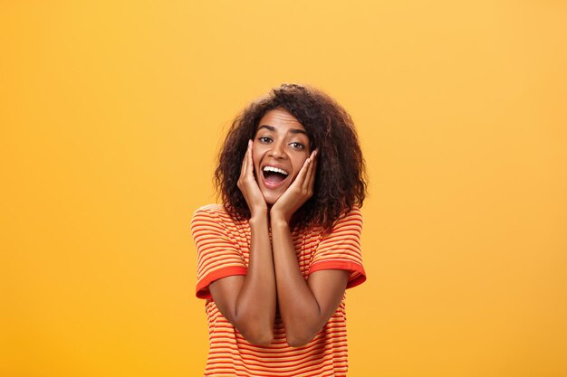 Portrait of woman wearing hat against yellow background