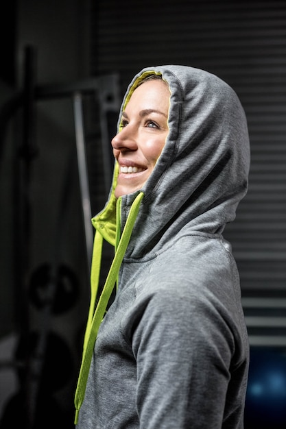 Portrait of woman wearing hood at crossfit gym