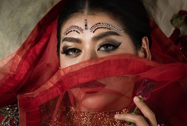 Portrait of woman wearing make up against black background