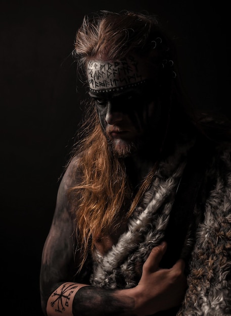 portrait of woman wearing mask against black background