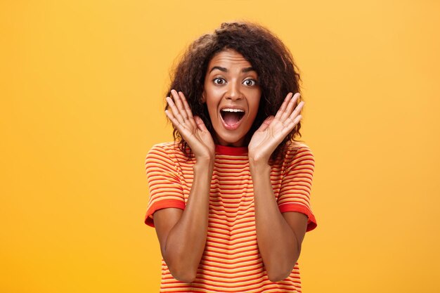 Portrait of woman wearing mask against yellow background