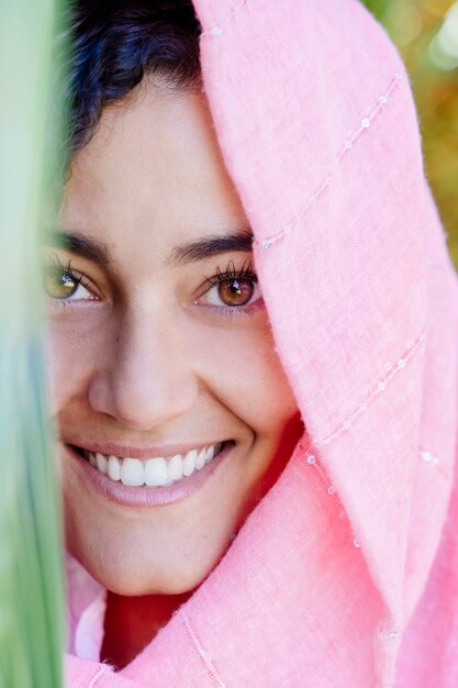 Portrait of woman wearing pink veil