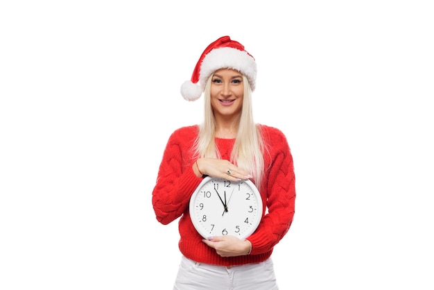 portrait woman wearing Santa hat holding clock