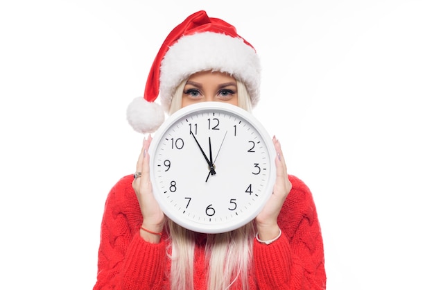 portrait woman wearing Santa hat holding clock