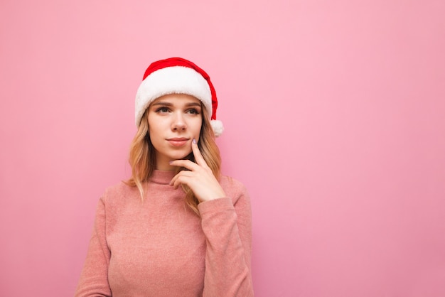 portrait woman wearing Santa hat with phone