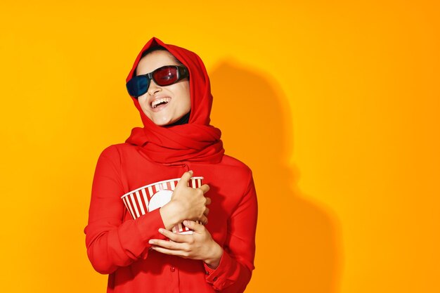 Portrait of woman wearing sunglasses against yellow background