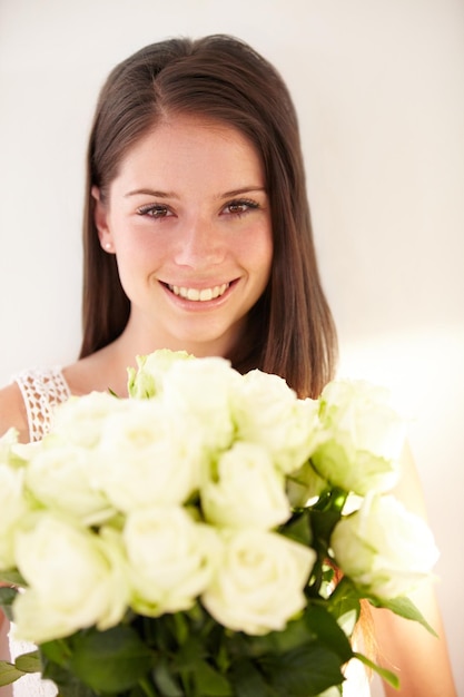 Portrait woman and white roses with beauty smile and achievement for romance happiness and excited Face man and woman with flower bouquet celebration or floral gift for joy or romantic gesture