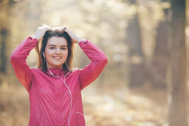 Portrait of a woman who trains and listens to music in headphones