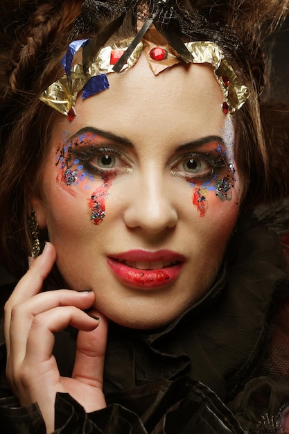 Portrait of woman with artistic makeup in blue smoke party theme