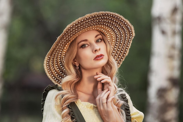 Portrait of a woman with blonde hair in retro clothes in a park or garden