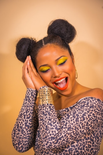 Premium Photo | Portrait of a woman with bright makeup and two side bun  hairstyle posing on green