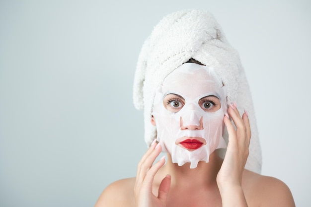 Portrait of a woman with a cotton mask to moisturize her face