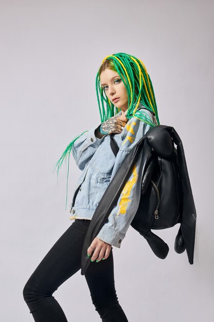 Photo portrait of a woman with creatively colored hair in green and yellow color.