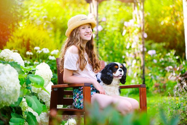 Portrait of woman with dog against plants