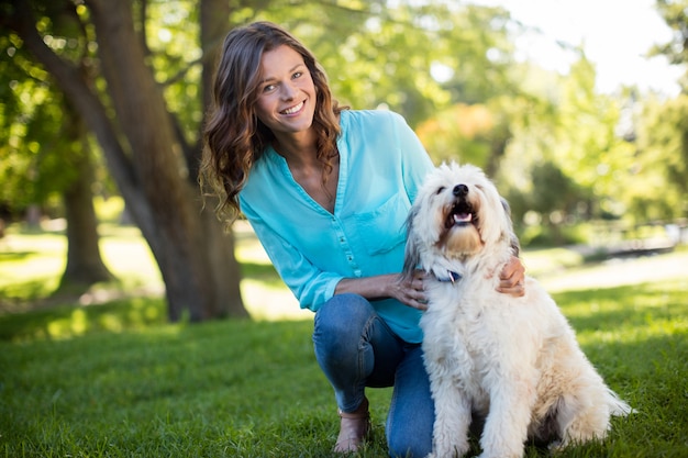 Portrait of woman with dog in park