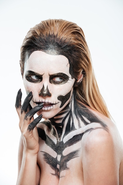 Portrait of woman with frightening scared makeup over white background