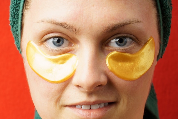 Portrait of a woman with golden patches closeup