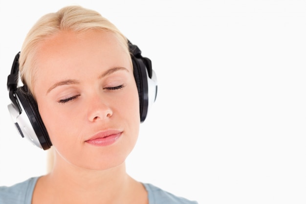 Portrait of a woman with headphones having eyes closed