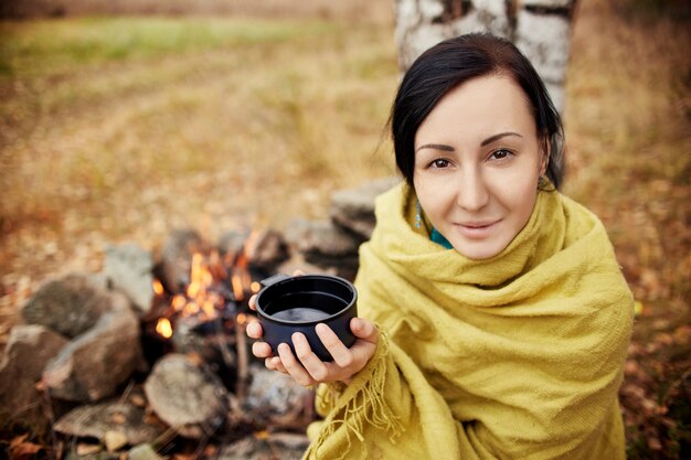 Portrait of a woman with a mug of hot tea in hands