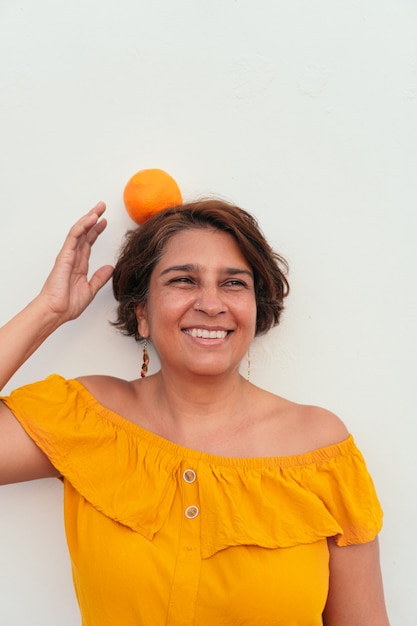 Portrait of a woman with an orange