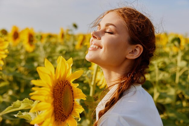 Portrait of woman with pigtails in nature field in sunflower posing high quality photo