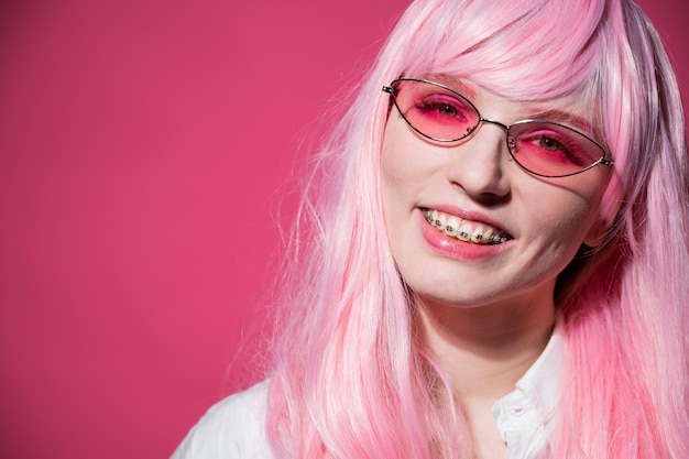 Portrait of woman with pink face against gray background