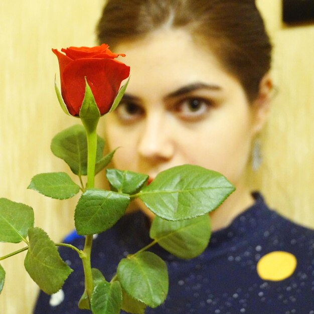 Portrait of woman with red flowers