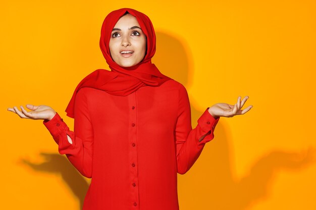 Portrait of woman with red hair against orange background