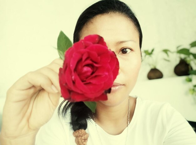 Portrait of woman with red rose