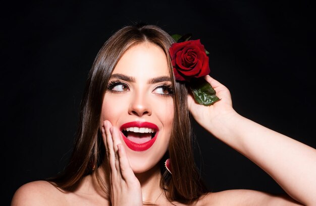 Photo portrait of a woman with a rose flower beauty fashion model woman face on a black background woman day concept