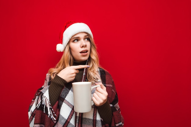 portrait woman with santa hat holding cup of coffee