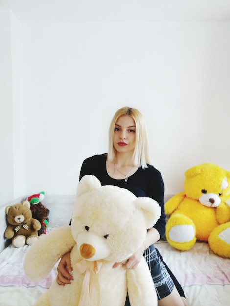 Portrait of woman with toy at home