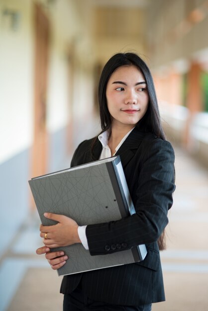 Portrait of a woman working in a black suit