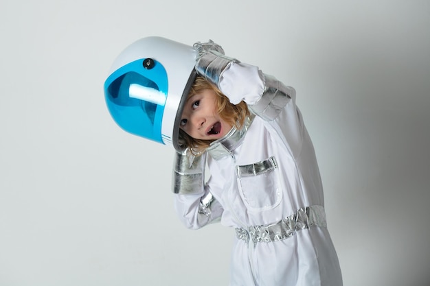 Photo portrait of wondered little astronaut in helmet and protective space suit funny little boy astronaut