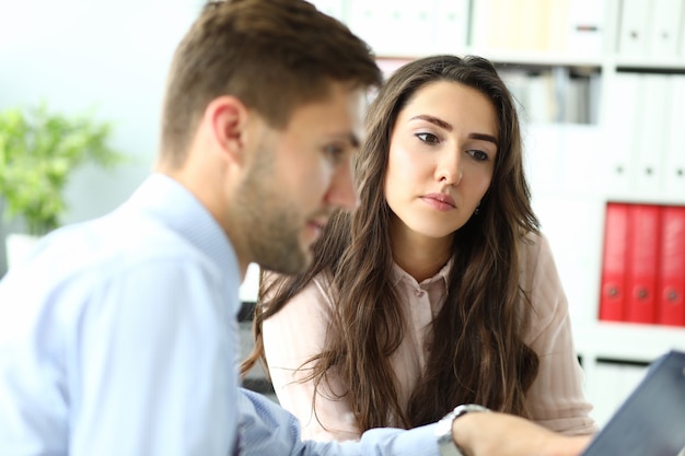 Portrait of wonderful woman discussing new start up with colleague