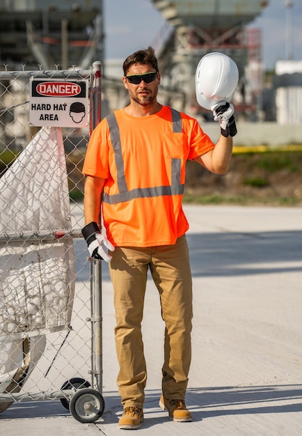 Portrait worker in construction helmet engineer builder foreman or repairman worker at building site