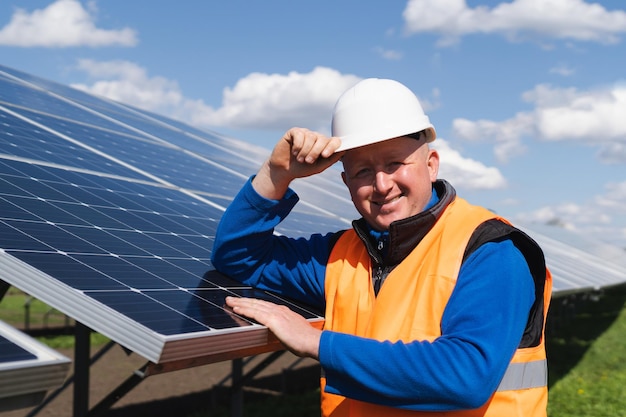 Portrait of a worker in hard hat at a solar power plant