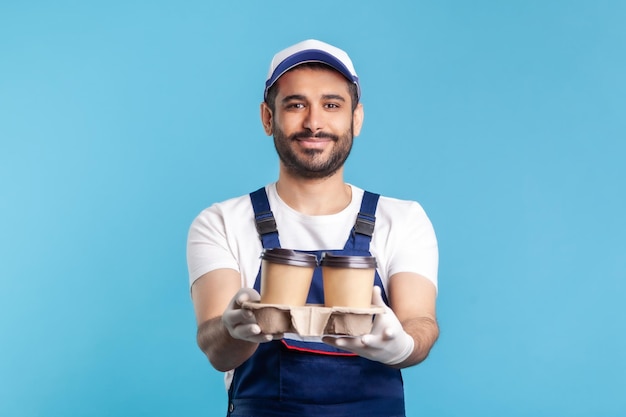 Portrait of worker man in uniform on blue background