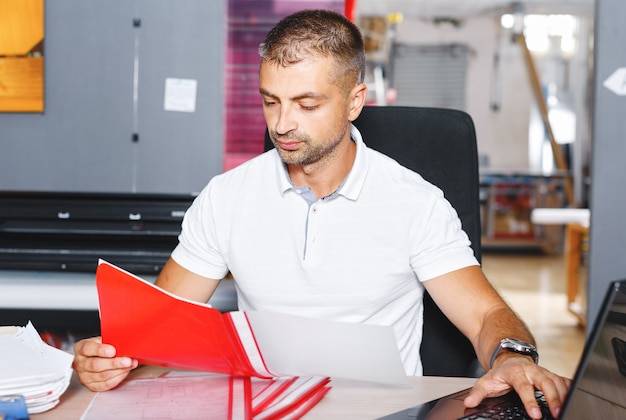 Portrait of a working man at a printer studio