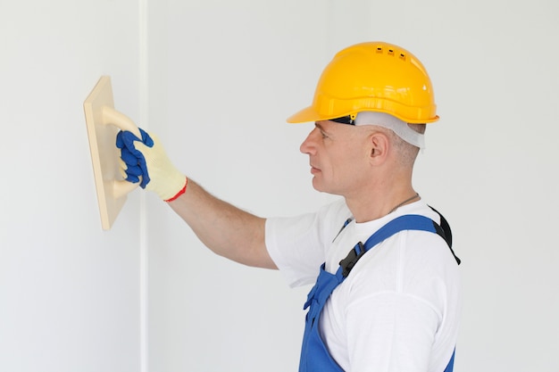 Portrait of workman polishing wall