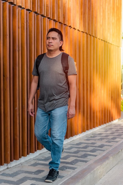 Portrait of young Aboriginal man outdoors with backpack