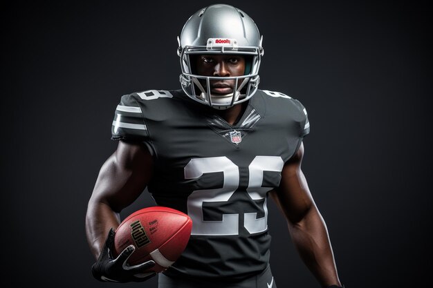 Portrait of a young african american football player on a dark background