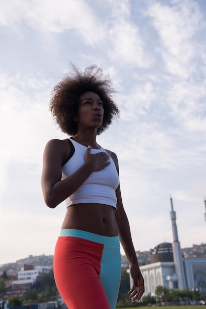 portrait of a young African American girl to run beautiful summer morning on city streets