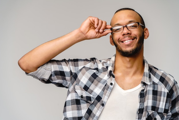 Portrait of a young african american over light grey background