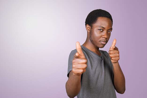 Portrait of young african-american man pointing at you