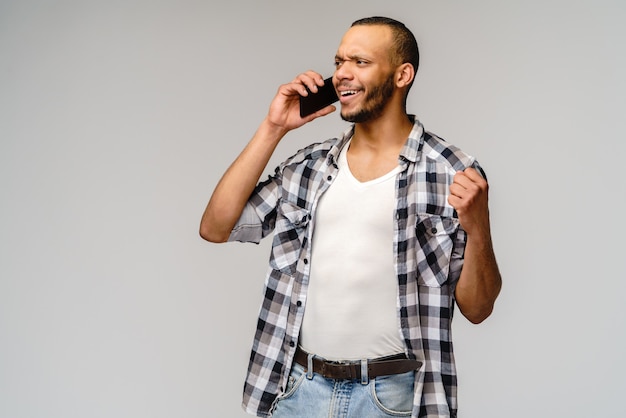 Portrait of a young african american man talking on the mobile cell phone