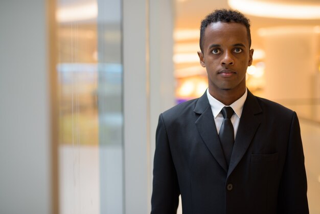 Portrait of young African businessman wearing suit